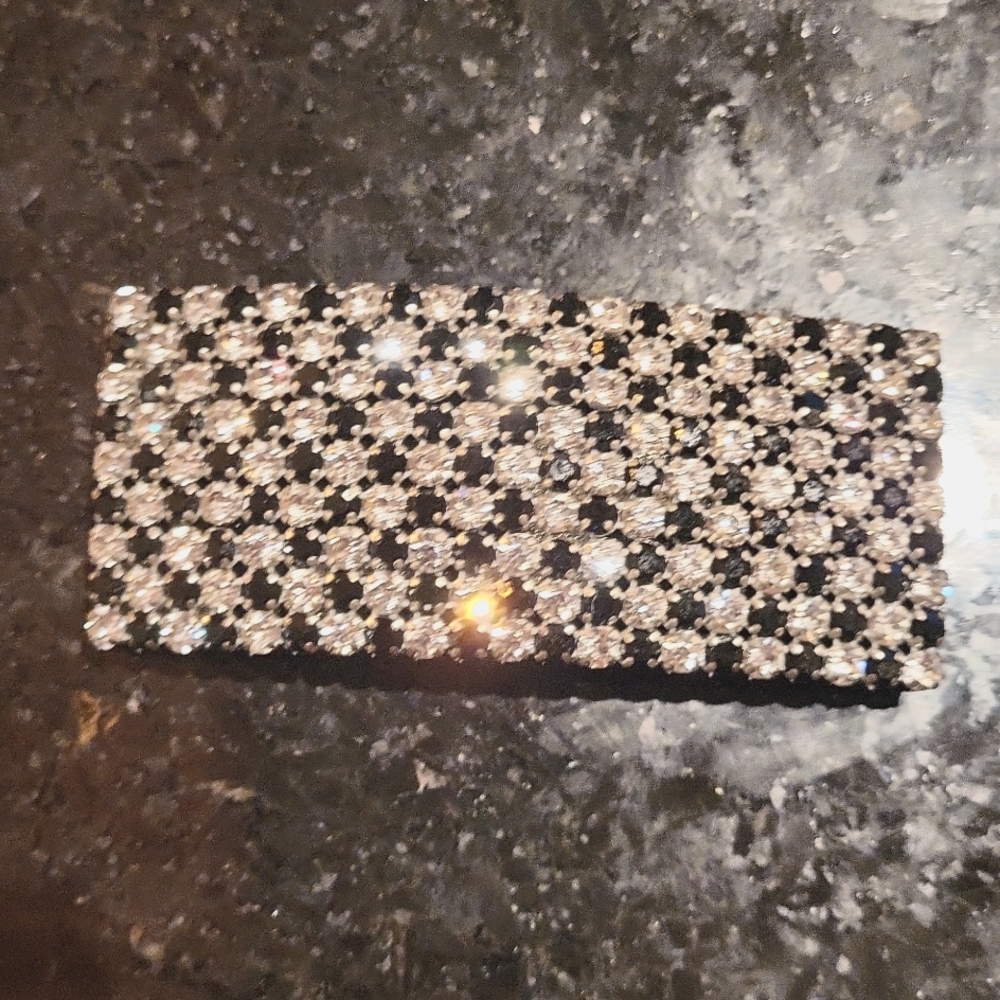 Black and clear encrusted prong set Barrett.